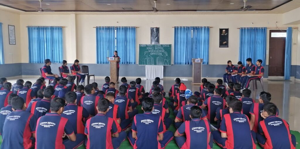 An Inter House Debate Competition took place on 4th August 2023 at Green Mount Global School Bhimtal. The event brought together students from different houses from senior classes to showcase their oratory and argumentative skills on the topic 'Reading book is better than watching television’. A total of four houses participated in this Inter House Debate Competition. Each participating house was represented by a team of two students: first one in favor of the topic and the other against the topic.  The event drew an enthusiastic response from both participants and spectators, contributing to a lively and engaging atmosphere. The topics chosen for the debate competition covered a wide range of social and political issues ensuring a balanced and comprehensive discussion. The participants demonstrated exceptional public speaking skills, critical thinking abilities, and the capacity to present well-reasoned arguments. They showcased a thorough understanding of the topic and expressed their views persuasively.